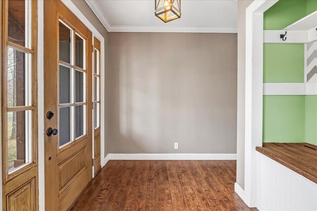 entrance foyer with baseboards, crown molding, and dark wood finished floors