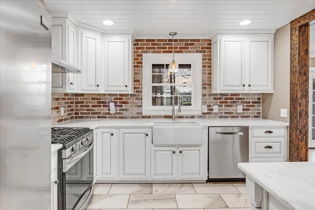 kitchen featuring white cabinets, light countertops, a sink, and appliances with stainless steel finishes