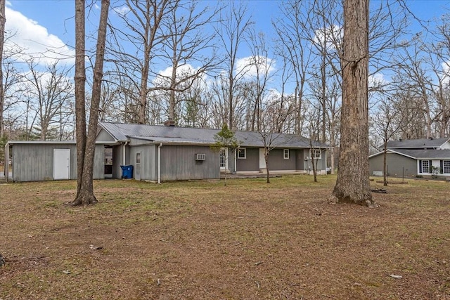rear view of property featuring metal roof