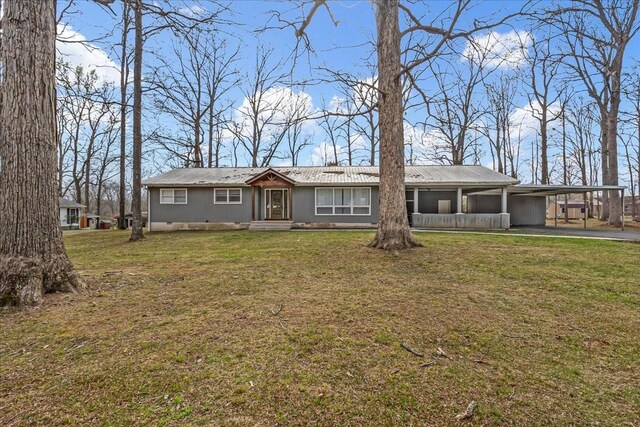 single story home featuring an attached carport, metal roof, crawl space, and a front yard