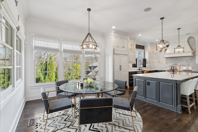 dining space featuring a chandelier, baseboards, ornamental molding, recessed lighting, and dark wood-type flooring