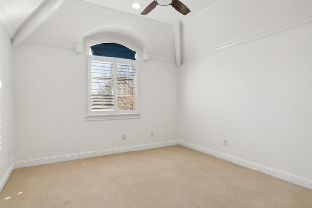 empty room featuring baseboards, ceiling fan, vaulted ceiling, and light colored carpet