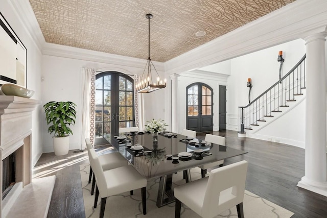 dining room featuring plenty of natural light, ornate columns, ornamental molding, an ornate ceiling, and french doors