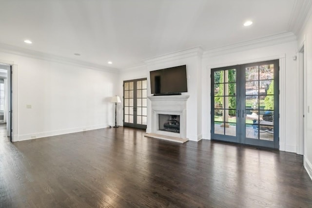 unfurnished living room with crown molding, a fireplace with raised hearth, dark wood-style floors, baseboards, and recessed lighting