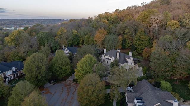 birds eye view of property featuring a view of trees