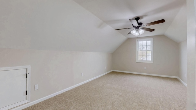 bonus room with baseboards, lofted ceiling, carpet floors, and a ceiling fan
