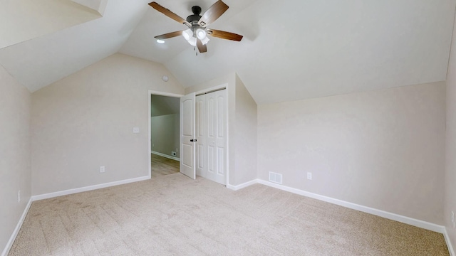 additional living space with baseboards, carpet flooring, vaulted ceiling, and a ceiling fan