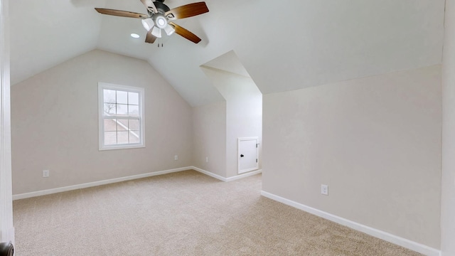 bonus room featuring a ceiling fan, carpet floors, baseboards, and lofted ceiling