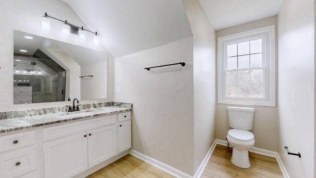 full bath with vanity, vaulted ceiling, toilet, a shower stall, and wood finished floors