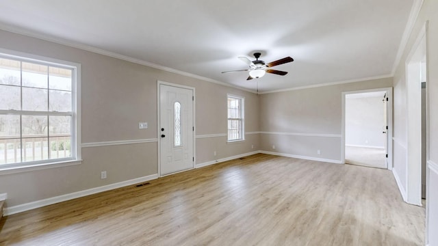 foyer featuring light wood finished floors, a wealth of natural light, visible vents, and ceiling fan