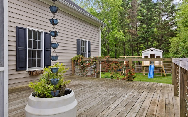 wooden deck with a storage shed and an outdoor structure
