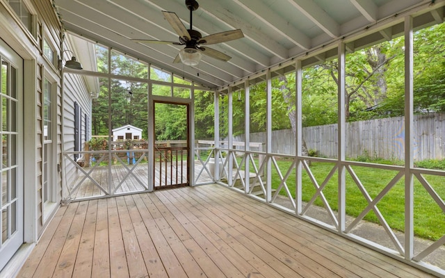 unfurnished sunroom with a ceiling fan