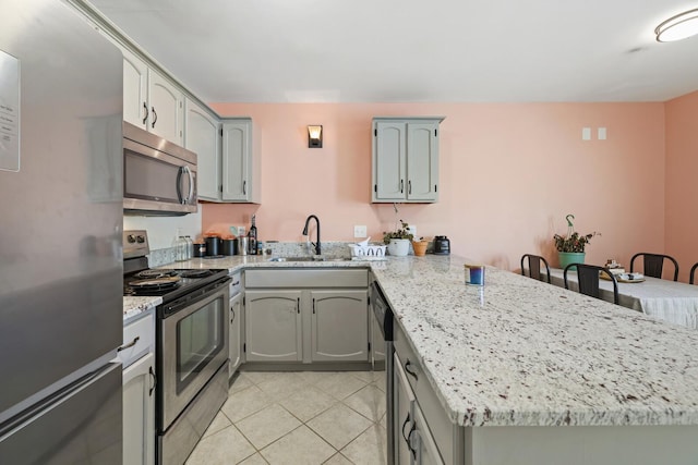 115 Northcrest Ct, Nashville, TN 37211 - kitchen featuring a sink, light stone countertops, a peninsula, light tile patterned floors, and stainless steel appliances