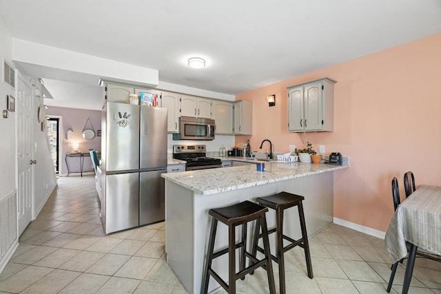 115 Northcrest Ct, Nashville, TN 37211 - kitchen with a kitchen breakfast bar, a sink, light tile patterned flooring, a peninsula, and appliances with stainless steel finishes