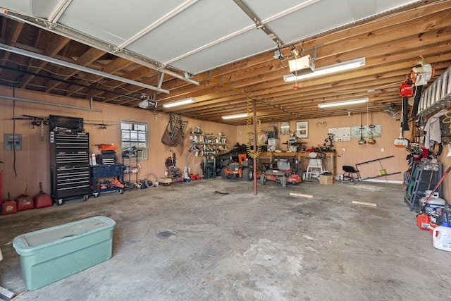 garage with a workshop area and a garage door opener