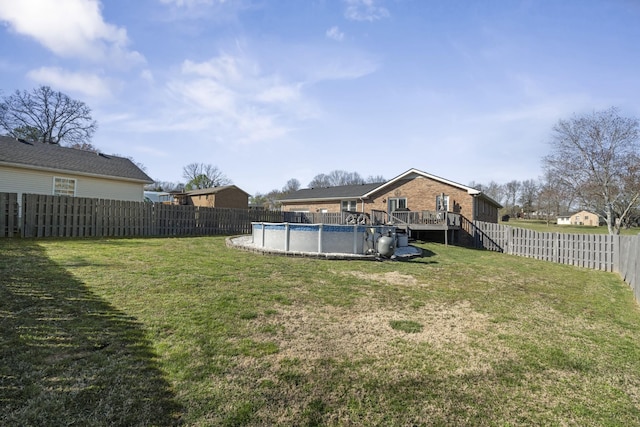view of yard with stairs, a fenced in pool, and a fenced backyard