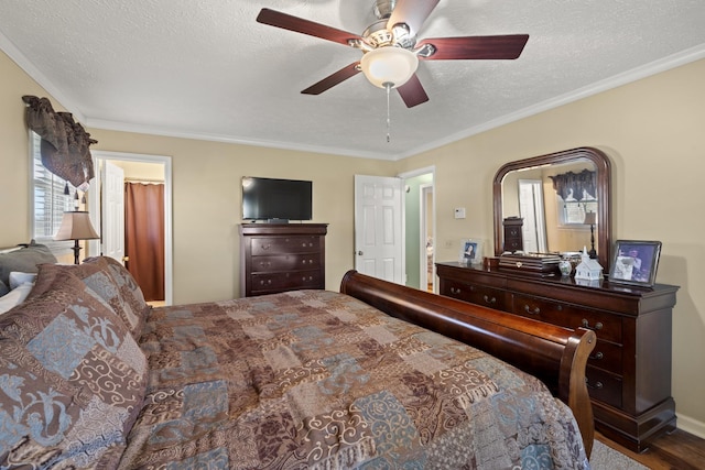 bedroom featuring a ceiling fan, wood finished floors, ornamental molding, and a textured ceiling