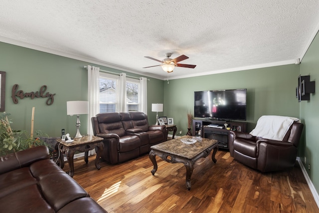 living room featuring a textured ceiling, crown molding, ceiling fan, and wood finished floors