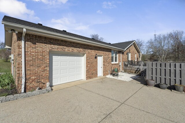 view of property exterior with brick siding, concrete driveway, and an attached garage