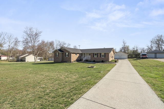 ranch-style home with brick siding, an outbuilding, a front lawn, and a detached garage
