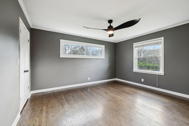 unfurnished bedroom featuring baseboards, wood finished floors, and multiple windows