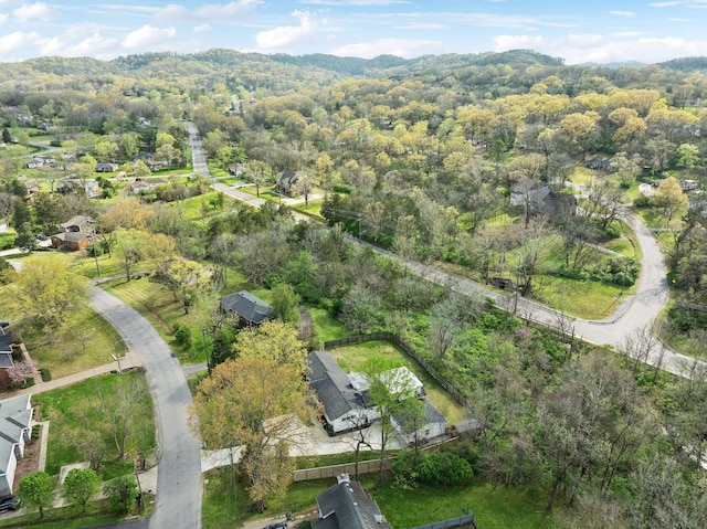 drone / aerial view featuring a wooded view