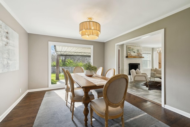 dining area featuring baseboards, wood finished floors, and a healthy amount of sunlight