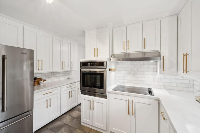 kitchen featuring white cabinets, under cabinet range hood, appliances with stainless steel finishes, and light countertops