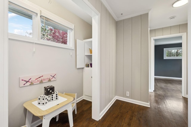 hall featuring baseboards and wood finished floors