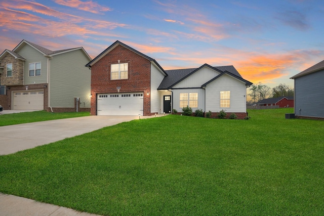 view of front of house featuring brick siding, a front yard, driveway, and an attached garage