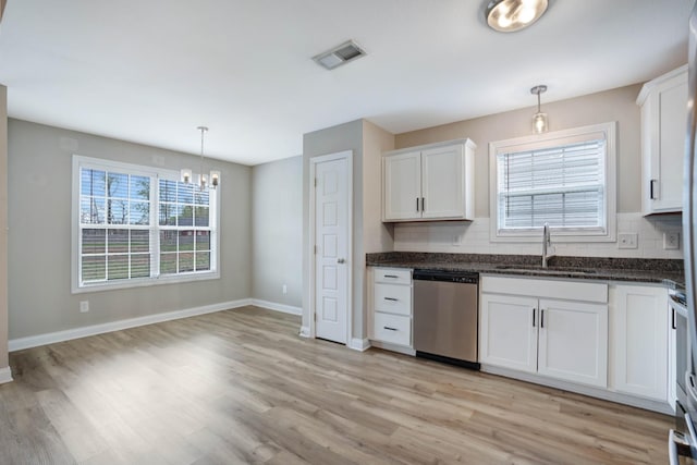 kitchen with a sink, tasteful backsplash, stainless steel dishwasher, visible vents, and an inviting chandelier