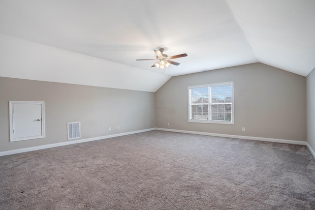 bonus room featuring vaulted ceiling, baseboards, carpet floors, visible vents, and a ceiling fan