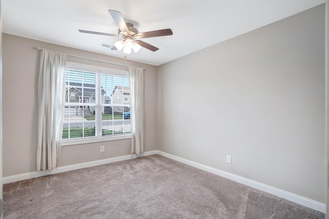 carpeted empty room featuring a ceiling fan, baseboards, and visible vents
