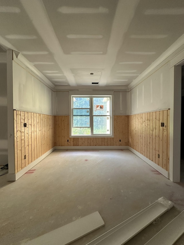 49 Copperas Creek Rd, Tullahoma, TN 37388 - unfurnished room with wainscoting, wooden walls, baseboards, and unfinished concrete flooring