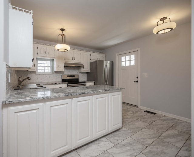 kitchen with a peninsula, marble finish floor, appliances with stainless steel finishes, under cabinet range hood, and a sink