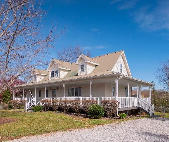 view of front of home with a front yard and a porch