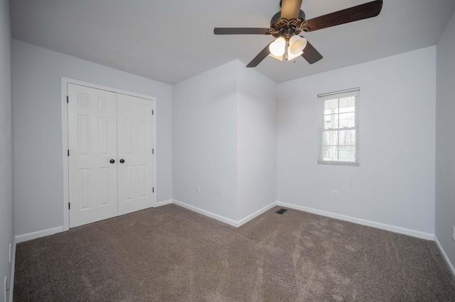 unfurnished bedroom featuring carpet flooring, a closet, and baseboards