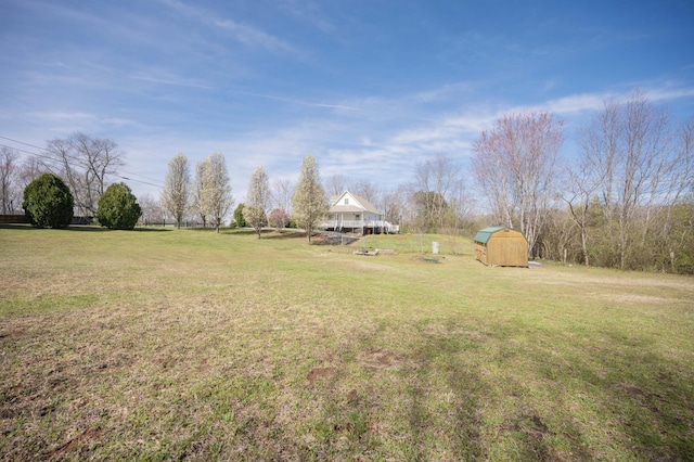 view of yard with an outdoor structure and a shed