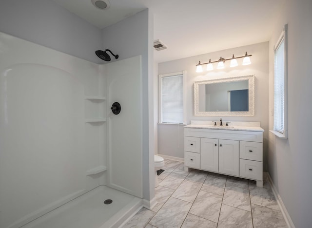 bathroom with marble finish floor, visible vents, and walk in shower