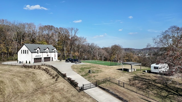 7990 Poplar Creek Rd, Nashville, TN 37221 - view of yard with fence, a garage, and concrete driveway