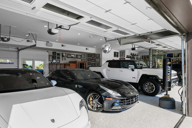 7990 Poplar Creek Rd, Nashville, TN 37221 - garage featuring visible vents and a garage door opener