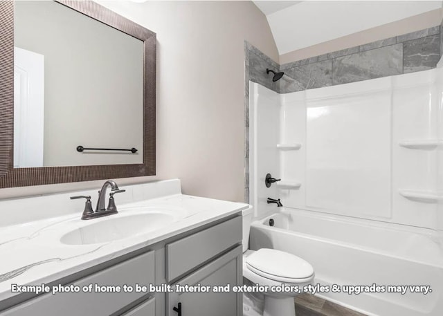 bathroom featuring tub / shower combination, vaulted ceiling, toilet, and vanity