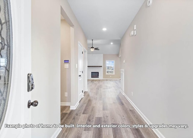 hallway featuring recessed lighting, baseboards, and wood finished floors