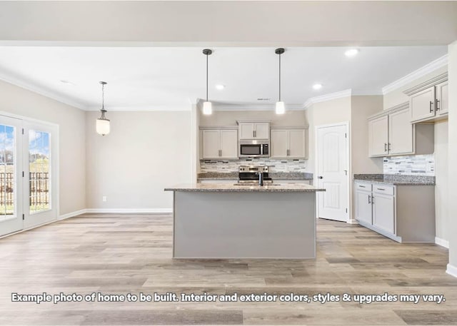 kitchen featuring tasteful backsplash, ornamental molding, stainless steel appliances, a sink, and light stone countertops