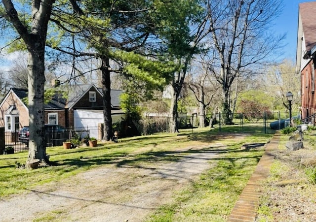 view of yard featuring driveway and fence