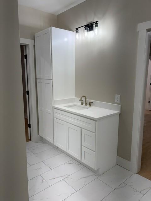 bathroom featuring a sink and marble finish floor