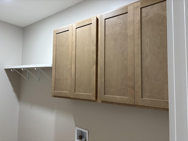 interior space featuring washer hookup and cabinet space