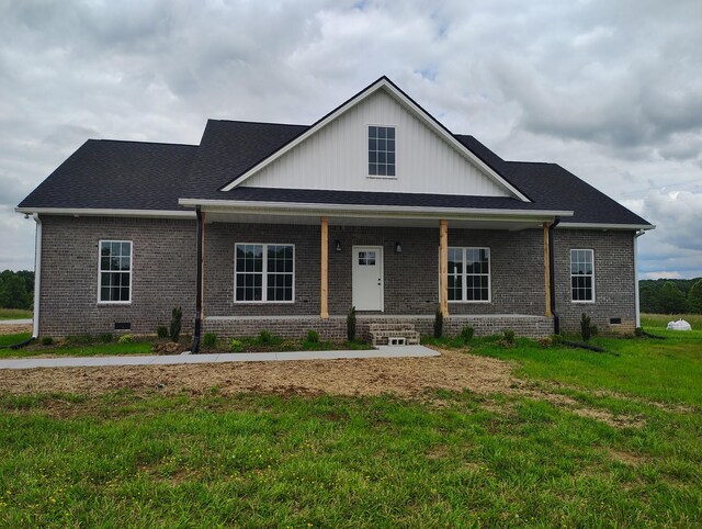 1452 Purtle Rd, Lafayette, TN 37083 - view of front of house with brick siding, crawl space, a front lawn, covered porch, and board and batten siding
