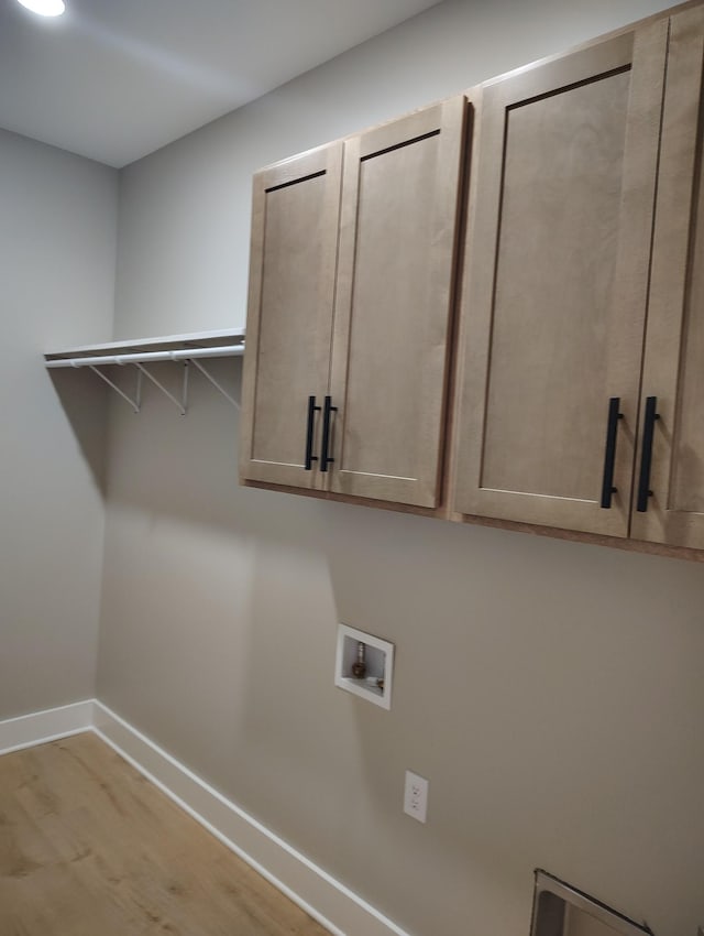 1452 Purtle Rd, Lafayette, TN 37083 - laundry area with baseboards, washer hookup, cabinet space, and wood finished floors