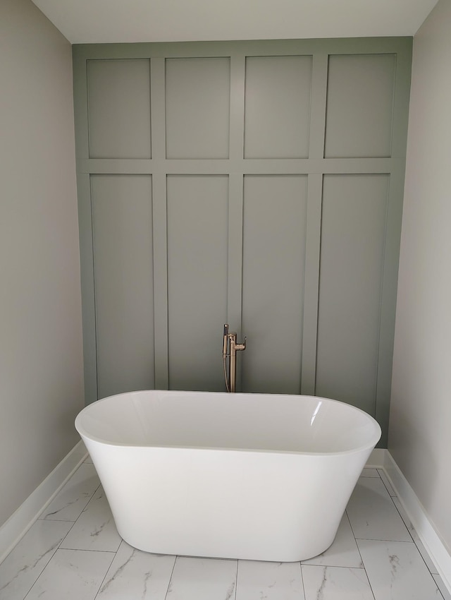 1452 Purtle Rd, Lafayette, TN 37083 - bathroom featuring marble look tile flooring, baseboards, and a soaking tub